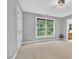 Bright bedroom with carpet, a large window, and neutral grey paint at 9 Monteith Ct, Durham, NC 27713