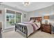 Bedroom with a large window, dark wood furniture, and neutral grey paint at 9 Monteith Ct, Durham, NC 27713
