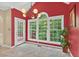 Dining room featuring large windows, an arched doorway, tile flooring, and a modern chandelier at 9 Monteith Ct, Durham, NC 27713