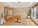 Formal dining area featuring hardwood floors, a modern light fixture, and a large display cabinet at 9 Monteith Ct, Durham, NC 27713