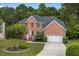 Beautiful brick home with well-manicured lawn, mature tree, and two-car garage at 9 Monteith Ct, Durham, NC 27713