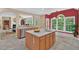 Kitchen features a large island, wood cabinets, stainless steel appliances, and an eat-in area at 9 Monteith Ct, Durham, NC 27713