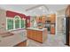 Spacious kitchen with stainless steel appliances, island, and breakfast nook with large windows at 9 Monteith Ct, Durham, NC 27713