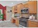 Kitchen boasts wood cabinets, a stainless steel oven, a built-in microwave, and tile backsplash at 9 Monteith Ct, Durham, NC 27713