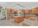 Large kitchen features a spacious island, wood cabinets, stainless steel appliances, and tile flooring at 9 Monteith Ct, Durham, NC 27713