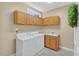 Functional laundry room with washer, dryer, sink, and ample cabinet storage at 9 Monteith Ct, Durham, NC 27713
