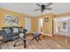 Cozy living room featuring hardwood floors, a ceiling fan, and an adjacent staircase at 9 Monteith Ct, Durham, NC 27713