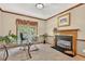 Bright home office features a fireplace, a glass desk, and a large window at 9 Monteith Ct, Durham, NC 27713