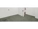 Bedroom with neutral walls, green carpet, and a door at 907 Morehead Ave, Durham, NC 27707
