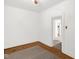 Bedroom with neutral walls, hardwood floors, and natural light filtering through the doorway at 907 Morehead Ave, Durham, NC 27707