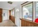Enclosed porch entryway with classic paneling, multiple windows, and a view of the outdoors at 907 Morehead Ave, Durham, NC 27707