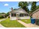 Exterior view of a cozy home featuring a well-manicured lawn at 907 Morehead Ave, Durham, NC 27707