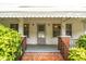 Inviting front porch with brick accents, and decorative railing offers a welcoming entry at 907 Morehead Ave, Durham, NC 27707