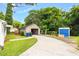 Property featuring a spacious driveway, a detached garage, and mature trees at 907 Morehead Ave, Durham, NC 27707