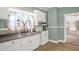 Cozy kitchen featuring white cabinets, a stainless steel sink, and classic white appliances at 907 Morehead Ave, Durham, NC 27707