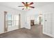 Inviting living room with a vintage fireplace, original windows, and classic French doors at 907 Morehead Ave, Durham, NC 27707