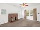 Inviting living room with a classic brick fireplace, large windows, and ceiling fan at 907 Morehead Ave, Durham, NC 27707