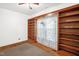 Cozy living room featuring built-in shelving, hardwood floors and a ceiling fan at 907 Morehead Ave, Durham, NC 27707