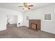 Cozy living room with a classic brick fireplace, and a ceiling fan at 907 Morehead Ave, Durham, NC 27707
