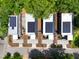 Aerial shot showcasing modern homes with solar panels and concrete pathways amid lush greenery at 922 Tower St, Raleigh, NC 27607