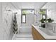 Bright bathroom featuring a tub, shower, double sink vanity, and eye-catching geometric tile at 922 Tower St, Raleigh, NC 27607