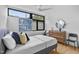 Well-lit bedroom with large windows, modern decor, and a comfortable bed with stylish pillows at 922 Tower St, Raleigh, NC 27607