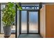 Modern entryway featuring frosted glass doors, sleek black frames, and stylish minimalist design elements at 922 Tower St, Raleigh, NC 27607