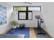 Inviting exercise room featuring workout bike, fitness mat, weights, and natural light at 922 Tower St, Raleigh, NC 27607