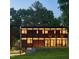 Modern home with wood and dark trim, expansive windows, and a well-maintained lawn at 922 Tower St, Raleigh, NC 27607