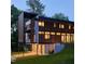 Striking modern home with multi-story balconies, wood accents, and a sleek design at 922 Tower St, Raleigh, NC 27607