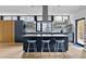 Modern kitchen with a central island, light wood floors, and stylish design features at 922 Tower St, Raleigh, NC 27607