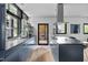 Modern kitchen featuring blue cabinets, stainless steel appliances, and large windows at 922 Tower St, Raleigh, NC 27607