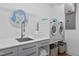 Clean laundry room with modern washer and dryer, stainless sink, and ample counter space at 922 Tower St, Raleigh, NC 27607