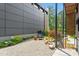 An inviting outdoor patio features a minimalist design, gravel flooring, and lush landscaping at 922 Tower St, Raleigh, NC 27607