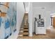 Modern staircase with hardwood steps and white walls with artwork at 922 Tower St, Raleigh, NC 27607