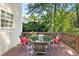 Relaxing back deck featuring a round table with seating and scenic backyard views at 9416 Buggy Run Cir, Wake Forest, NC 27587