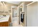 Well-lit bathroom showcasing a walk-in shower, vanity with sink, and linen storage at 9416 Buggy Run Cir, Wake Forest, NC 27587
