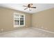 Neutral bedroom featuring carpet, ceiling fan, and window allowing natural light at 9416 Buggy Run Cir, Wake Forest, NC 27587