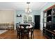 Elegant dining room showcasing a classic chandelier, a dark wood table, and seamless flow into other living spaces at 9416 Buggy Run Cir, Wake Forest, NC 27587