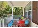Relaxing front porch with comfortable seating, featuring a decorative rug and a view of the lush greenery at 9416 Buggy Run Cir, Wake Forest, NC 27587
