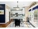 Modern kitchen with stainless steel appliances, white cabinets, and a cozy dining area with seating for casual meals at 9416 Buggy Run Cir, Wake Forest, NC 27587