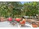 Outdoor patio area with brick surround, comfortable seating, and views of lush landscaping at 9416 Buggy Run Cir, Wake Forest, NC 27587