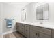 This bathroom features dual sinks, quartz countertops, gray cabinetry, framed mirrors and modern lighting at 1004 Snow Peak Ct, Raleigh, NC 27603