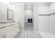 Elegant bathroom features tiled floors, double vanity with granite counters, and a walk-in shower at 1004 Snow Peak Ct, Raleigh, NC 27603