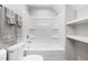 A clean, bright bathroom features a white tub and shower combination and open shelving at 1004 Snow Peak Ct, Raleigh, NC 27603