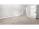 A bright bonus room is carpeted and features neutral walls, a closet, and an open doorway at 1004 Snow Peak Ct, Raleigh, NC 27603