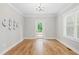 Bright dining room features wood floors, crown moulding, modern chandelier and door to back deck at 1004 Snow Peak Ct, Raleigh, NC 27603