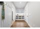 Walk-in pantry with built-in shelving, decorative accents, a beverage center and hardwood flooring at 1004 Snow Peak Ct, Raleigh, NC 27603