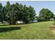 Expansive backyard featuring lush green lawn and mature trees at 1035 Evening Shade Ave, Rolesville, NC 27571