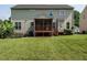 Lush backyard featuring a screened porch and well-manicured lawn at 1035 Evening Shade Ave, Rolesville, NC 27571